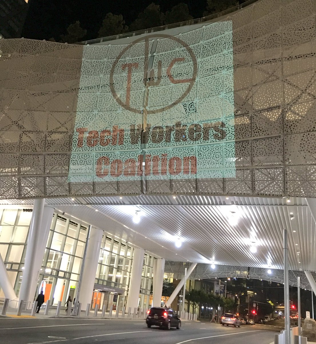Photo of the Salesforce Transit Center in San Francisco with the TWC logo projected onto it
