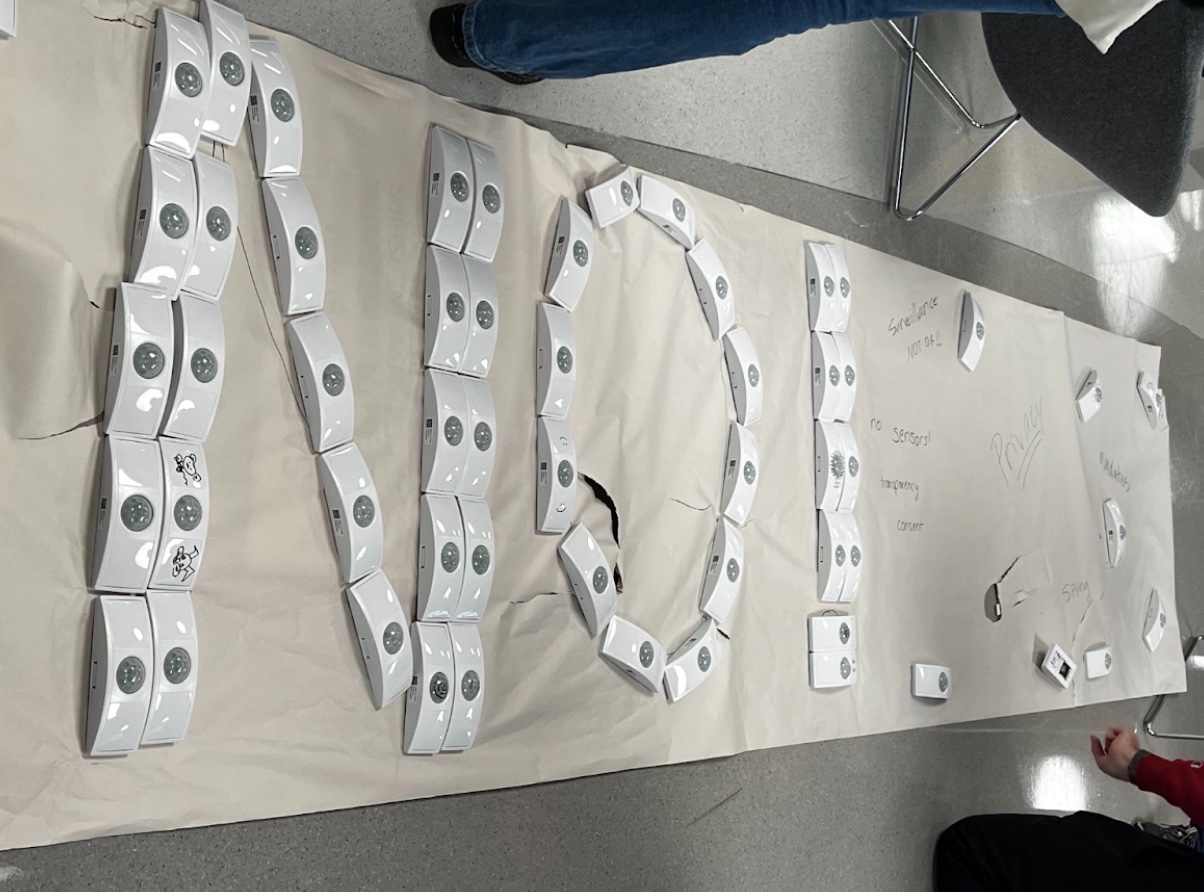 A few dozen motion sensor devices arranged on the floor to spell out NO!