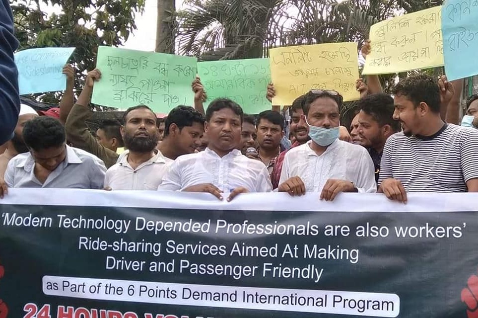A photo of dozens of drivers marching with a banner that reads, Modern Technology Depended Professionals are also workers - and a list of six demands